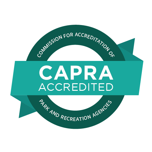 A seal indicating CAPRA accreditation. Reads 'Commission for Accreditation of Park and Recreation Agencies - CAPRA Accredited'.